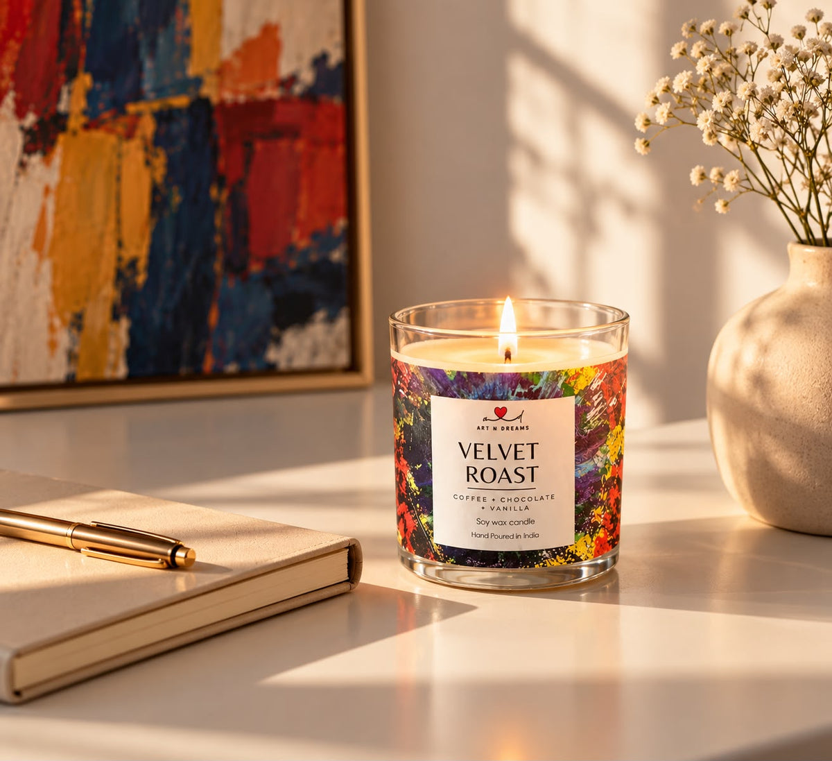 Velvet Roast candle in bright daylight with abstract painting