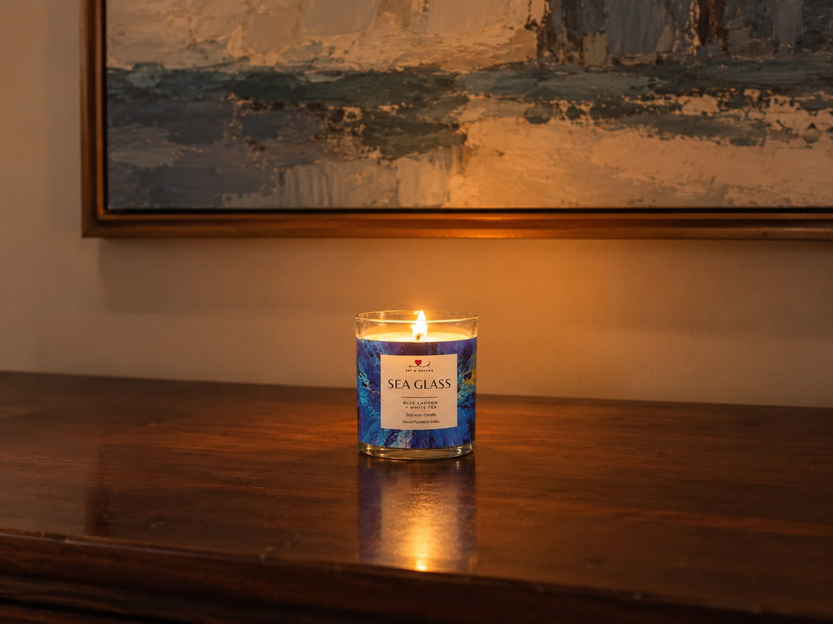 Sea Glass candle surrounded by sea glass, coral and white flowers
