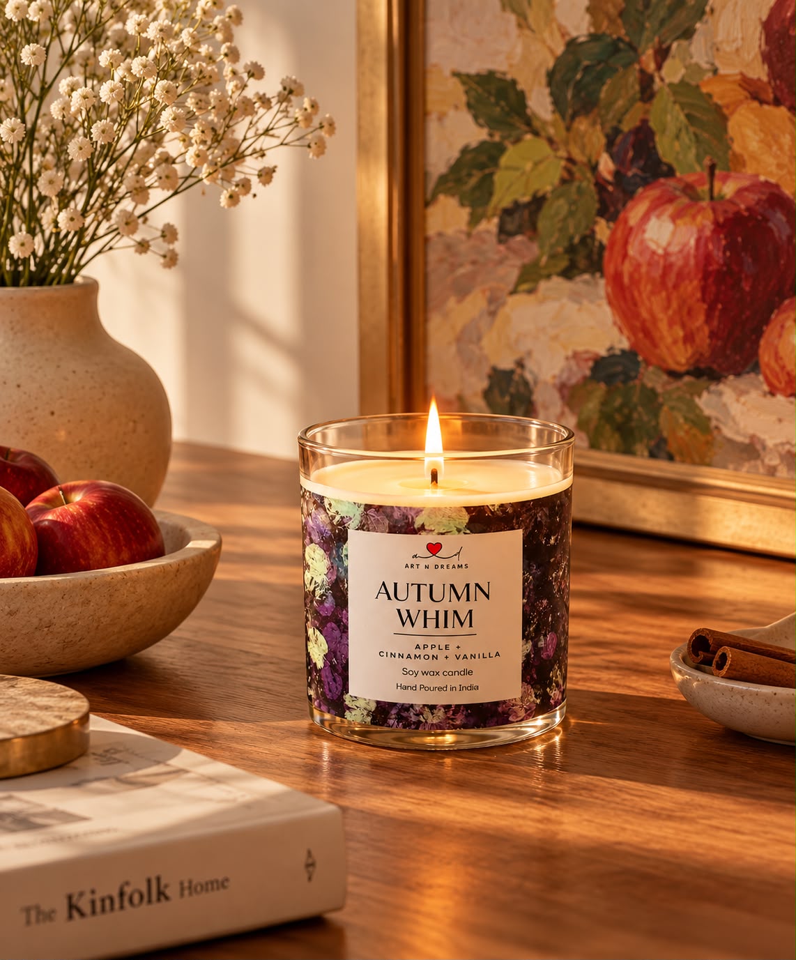 Autumn Whim candle glowing on a desk beside a laptop, coffee and journal